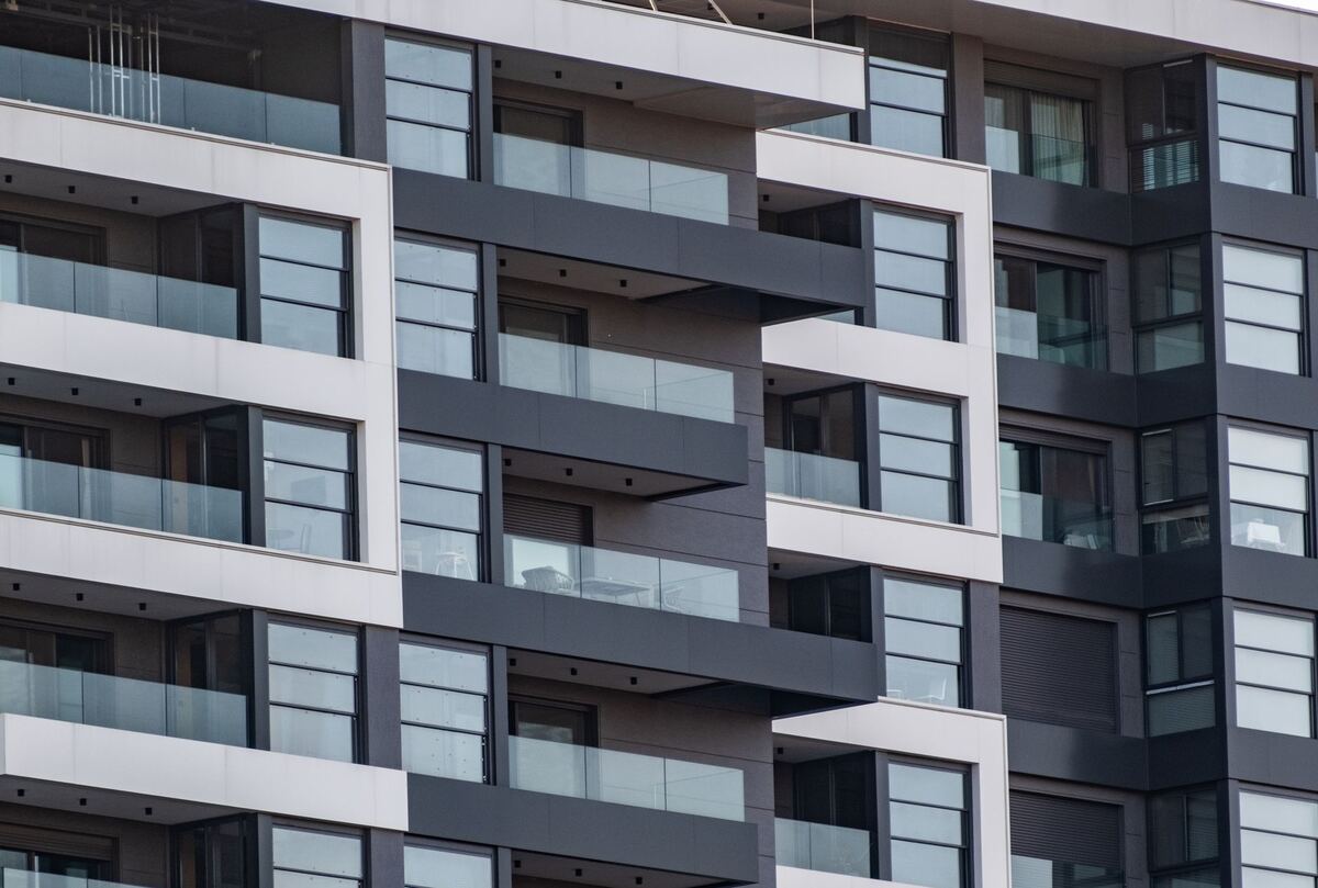 Grid of balconies across a tall apartment building