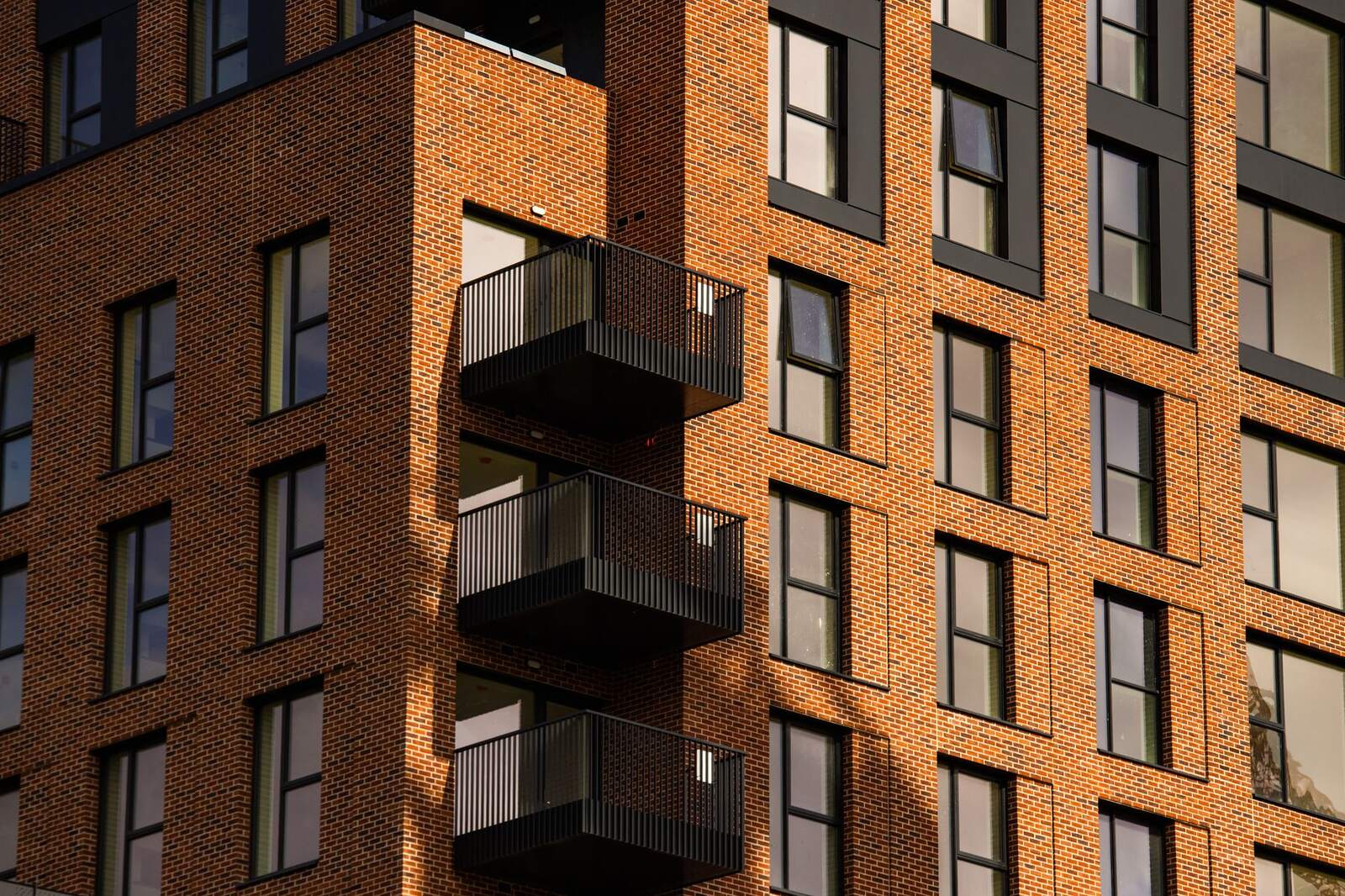 Brick apartment building with black steel balconies