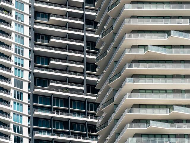 Curved residential tower with stacked balconies