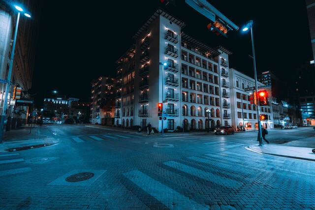 Balconied buildings at a downtown San Antonio corner at night