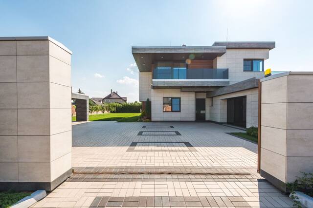 Gated entry opening onto a paved private drive