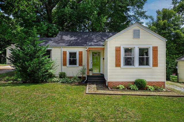 Small single-story house with a trimmed front lawn
