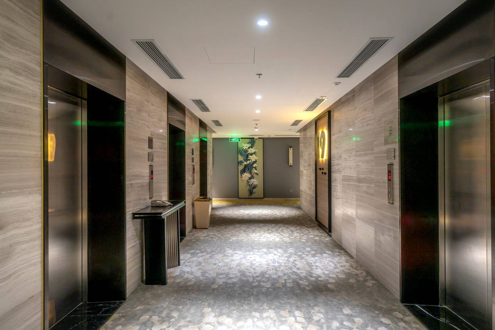 Interior corridor with elevator doors on either side