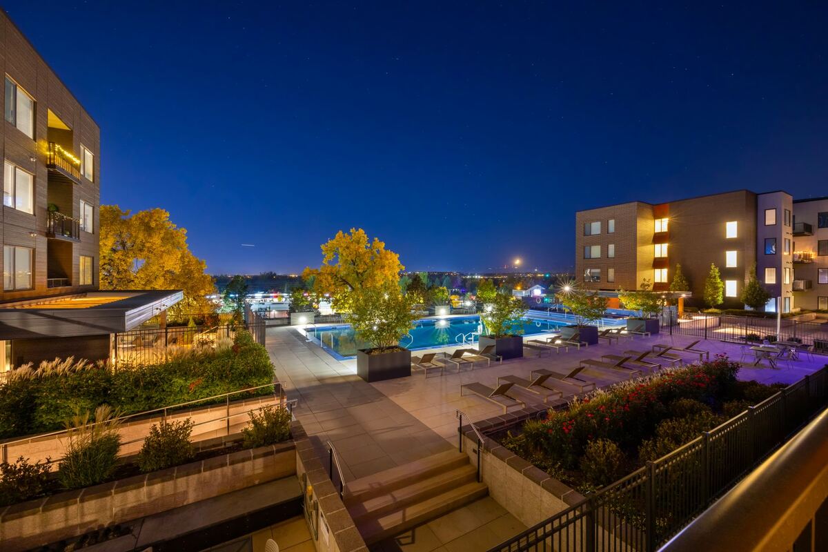 Apartment courtyard pool lit at dusk