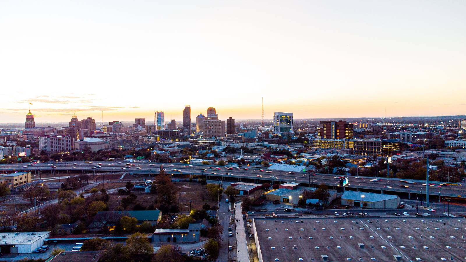 The San Antonio skyline at dusk above the highway