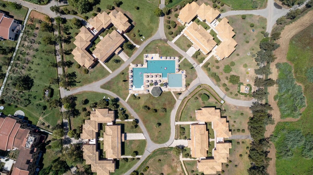 Aerial view of garden apartment buildings set around a pool