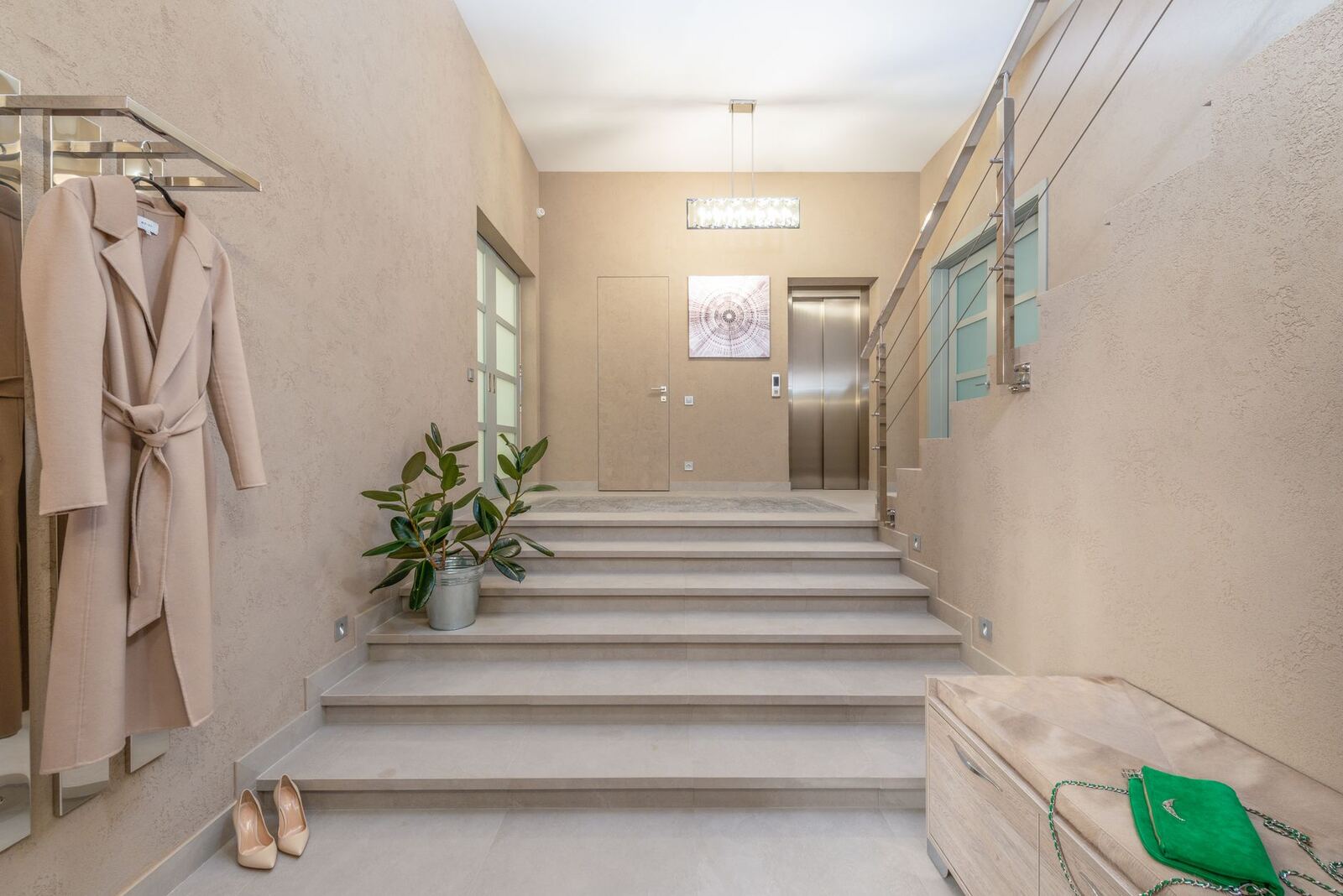 Apartment lobby with a short flight of steps and an elevator door
