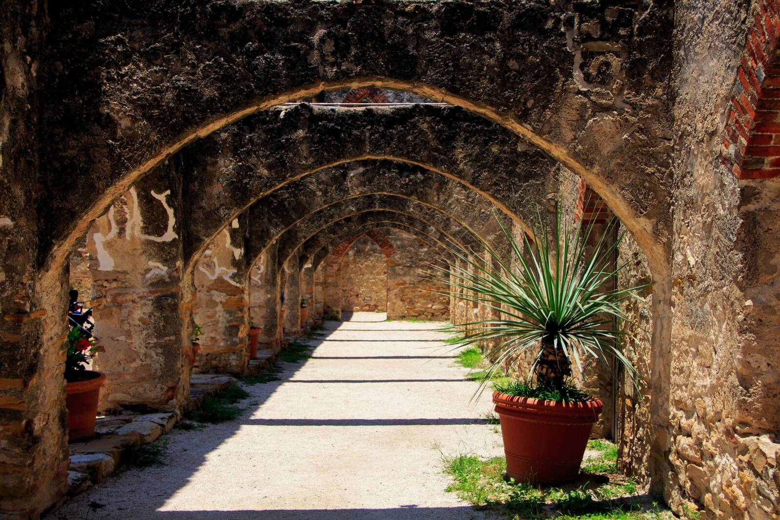Arched stone corridor at a historic San Antonio mission
