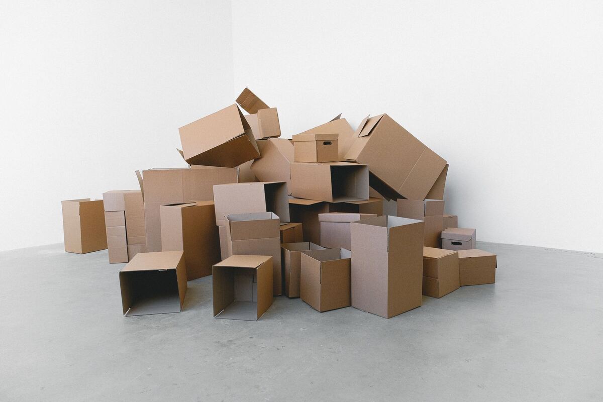 Cardboard moving boxes piled on a bare floor