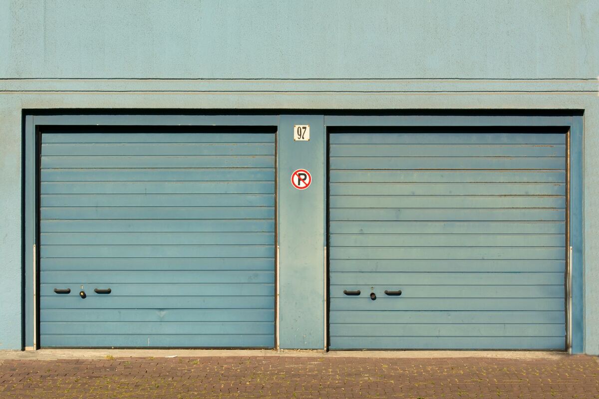Pair of teal garage doors on a low building
