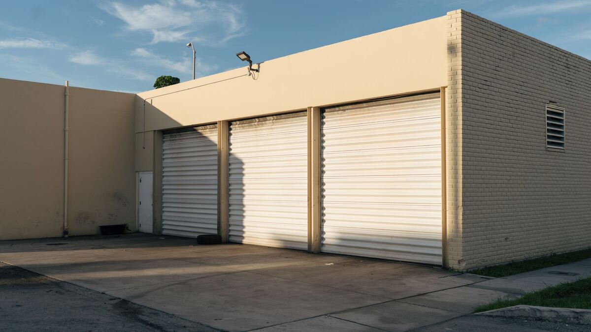 White roller doors on a low storage building