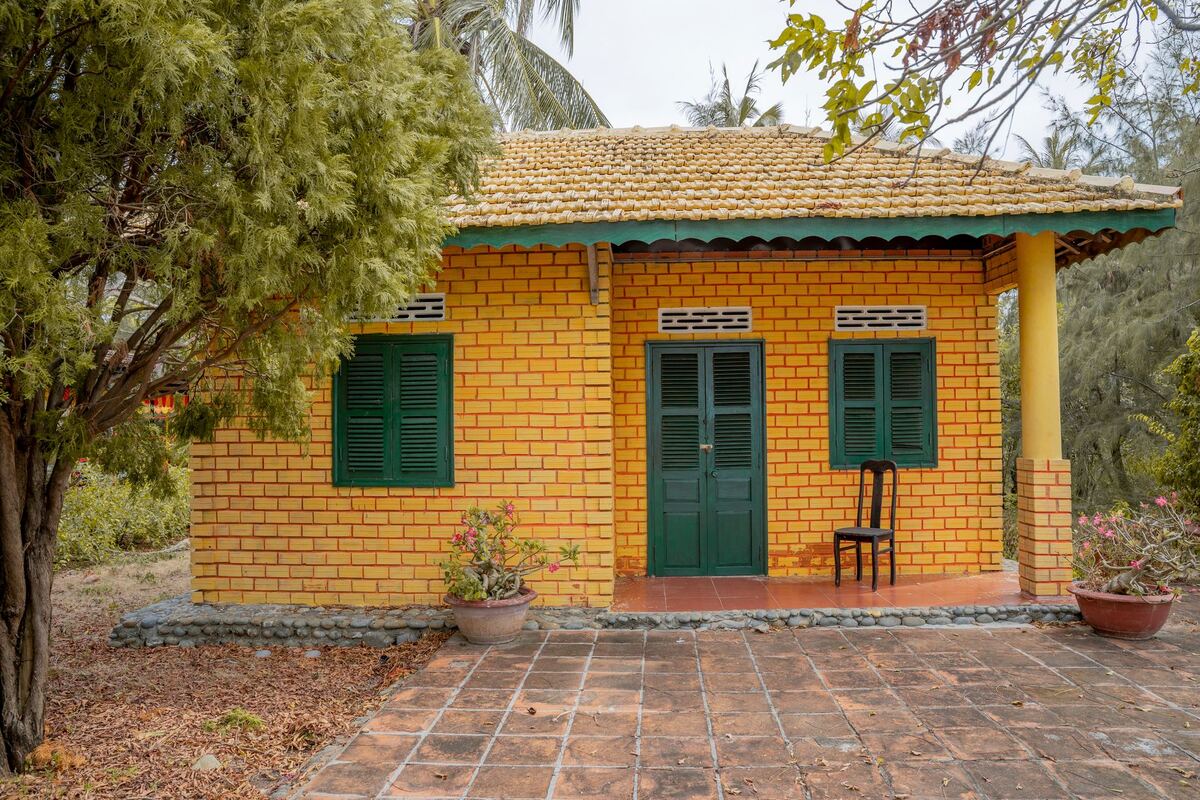 Single-story cottage with a tiled roof and planted surround